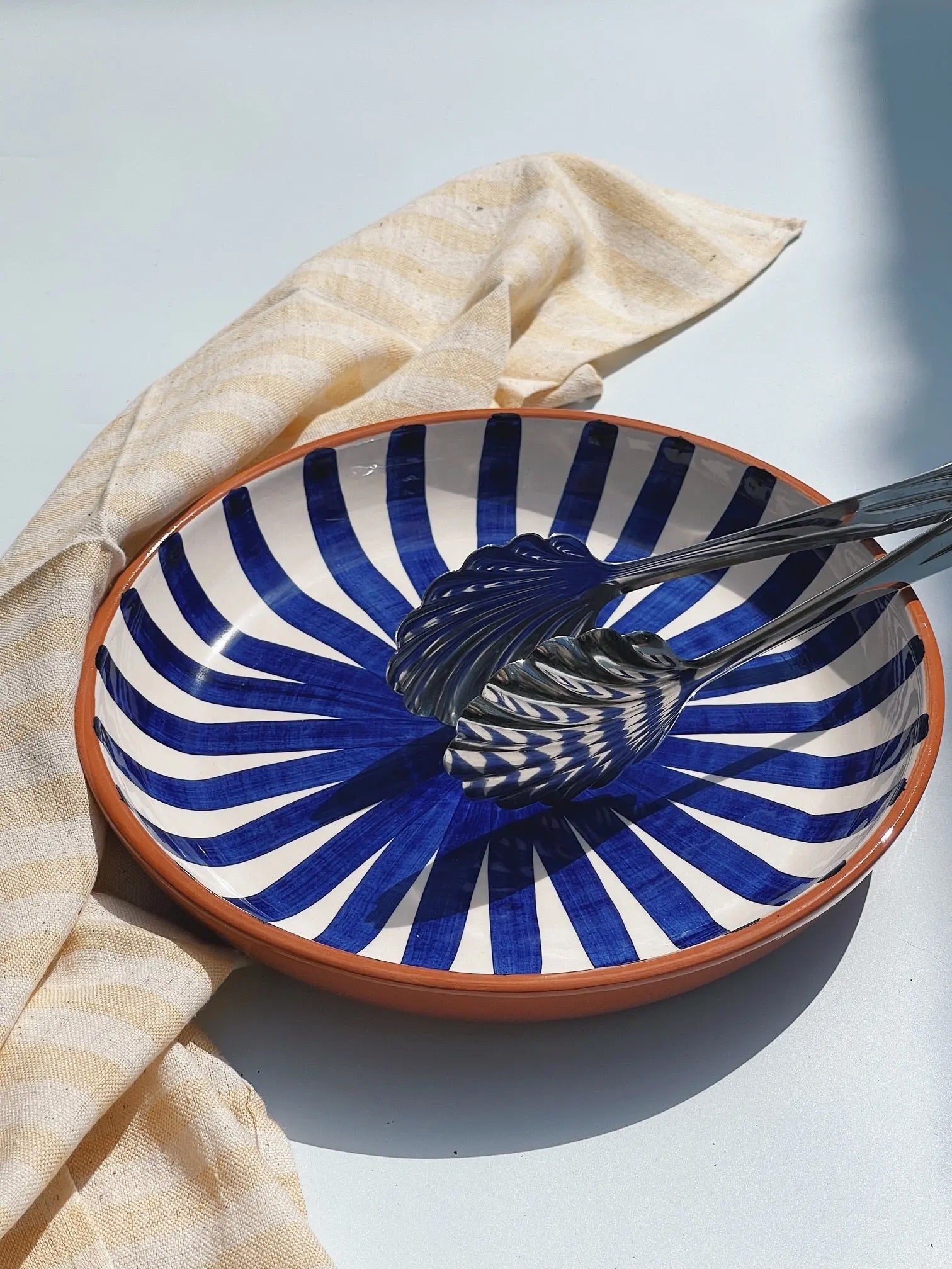 Casa Cubista Ray dish in terracotta with hand-painted blue and white stripes