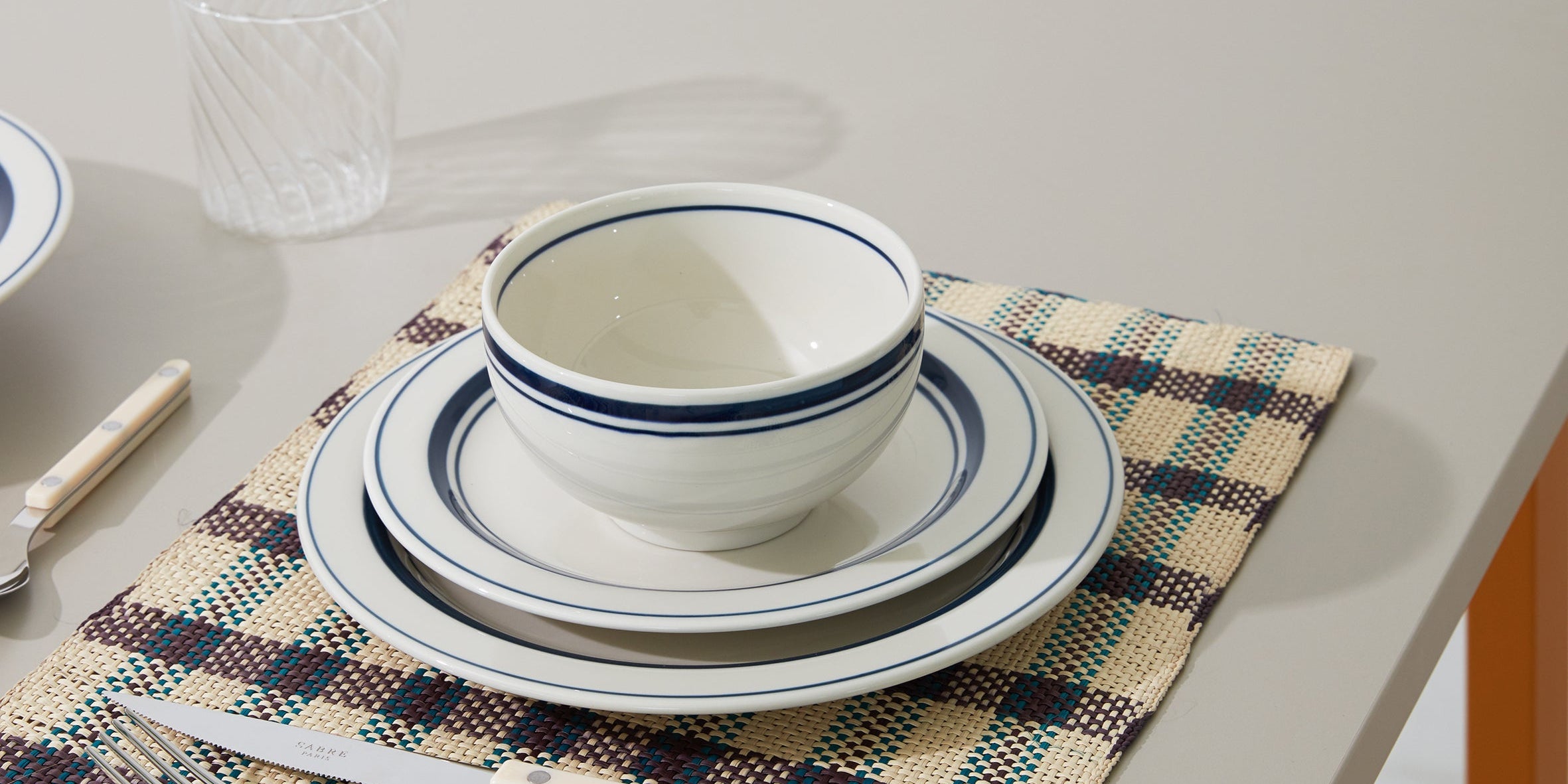 Japanese ceramic plates and bowl with blue rim on a table setting – Studio Hafnia