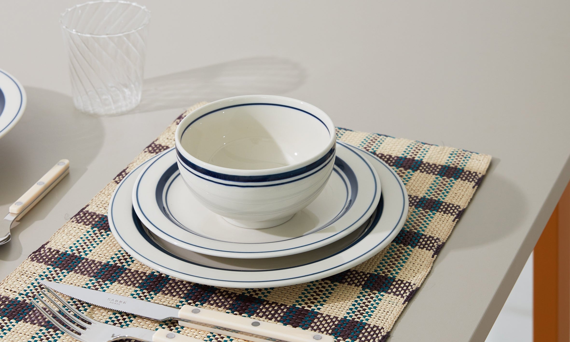 Japanese ceramic plates and bowl with blue rim on a table setting – Studio Hafnia