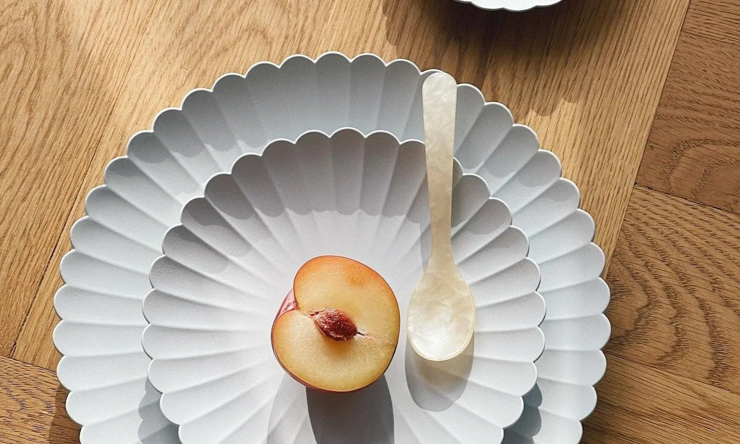 arita Japan – flower-shaped grey porcelain plates in three sizes, designed by Teruhiro Yanagihara