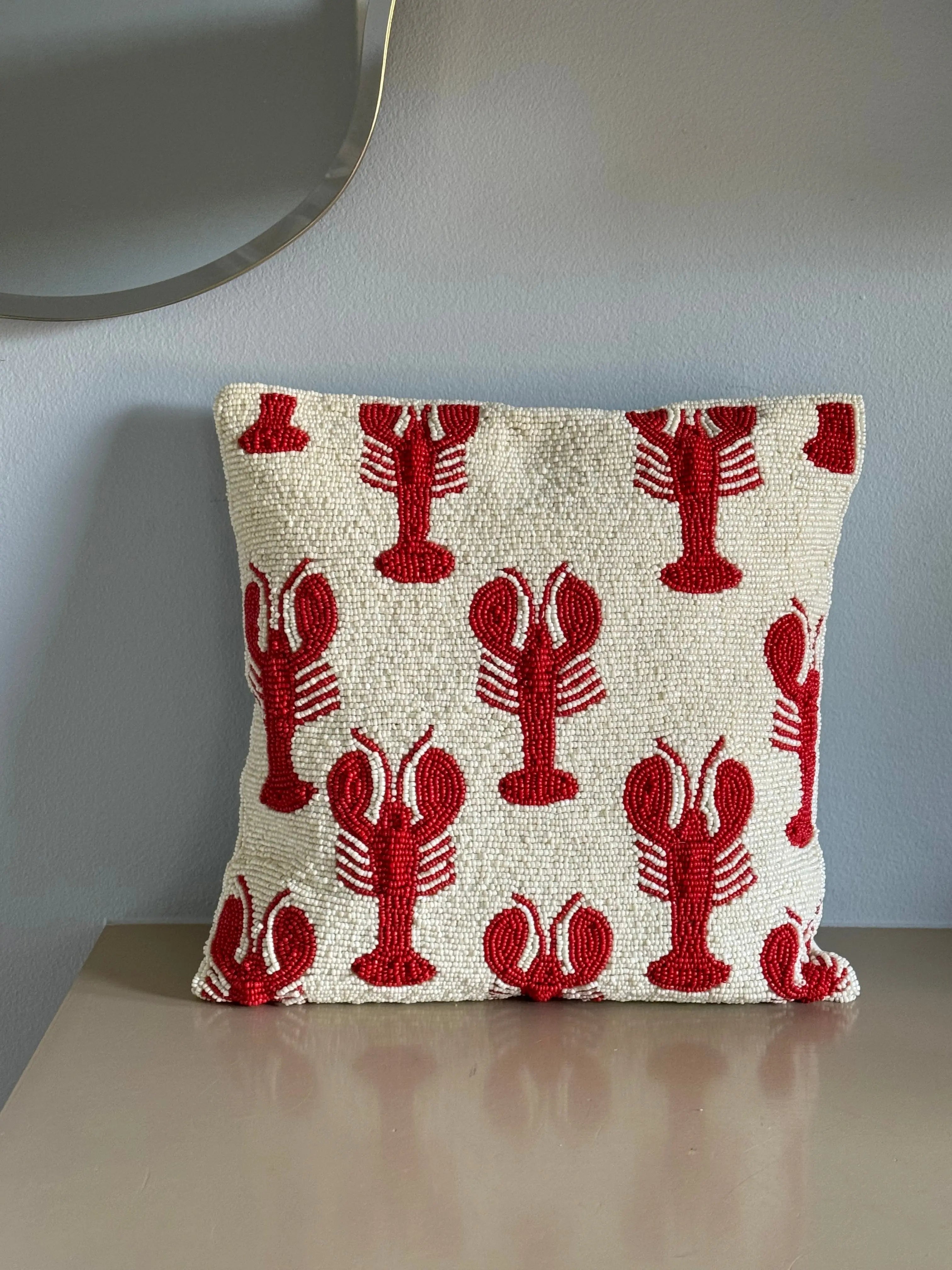 Decorative cushion cover in white with red lobster pattern, handcrafted detail for sofa or armchair.