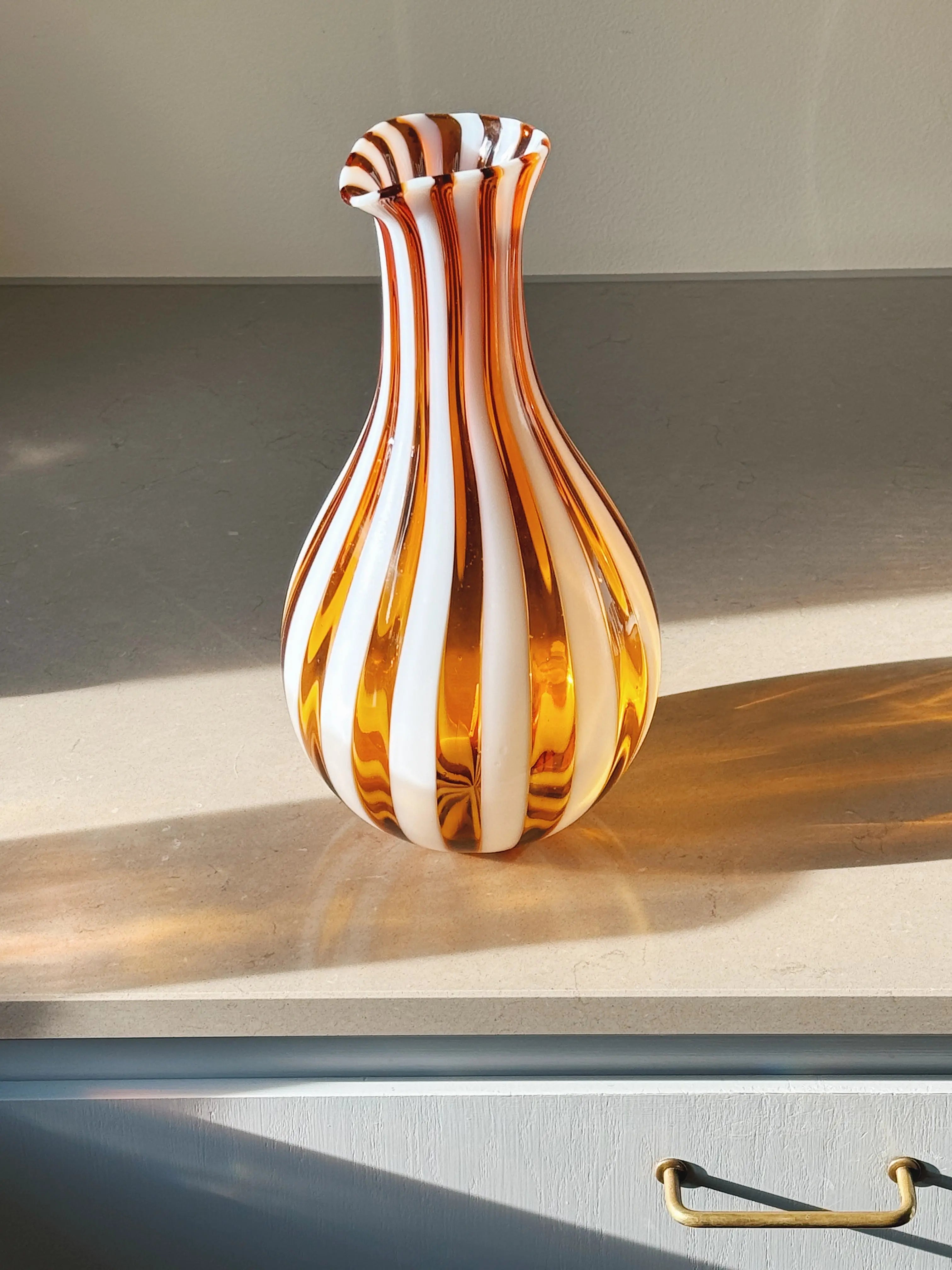 Hand-blown Murano glass carafe with orange and white striped design – unique Italian jug for serving water, wine or flowers.