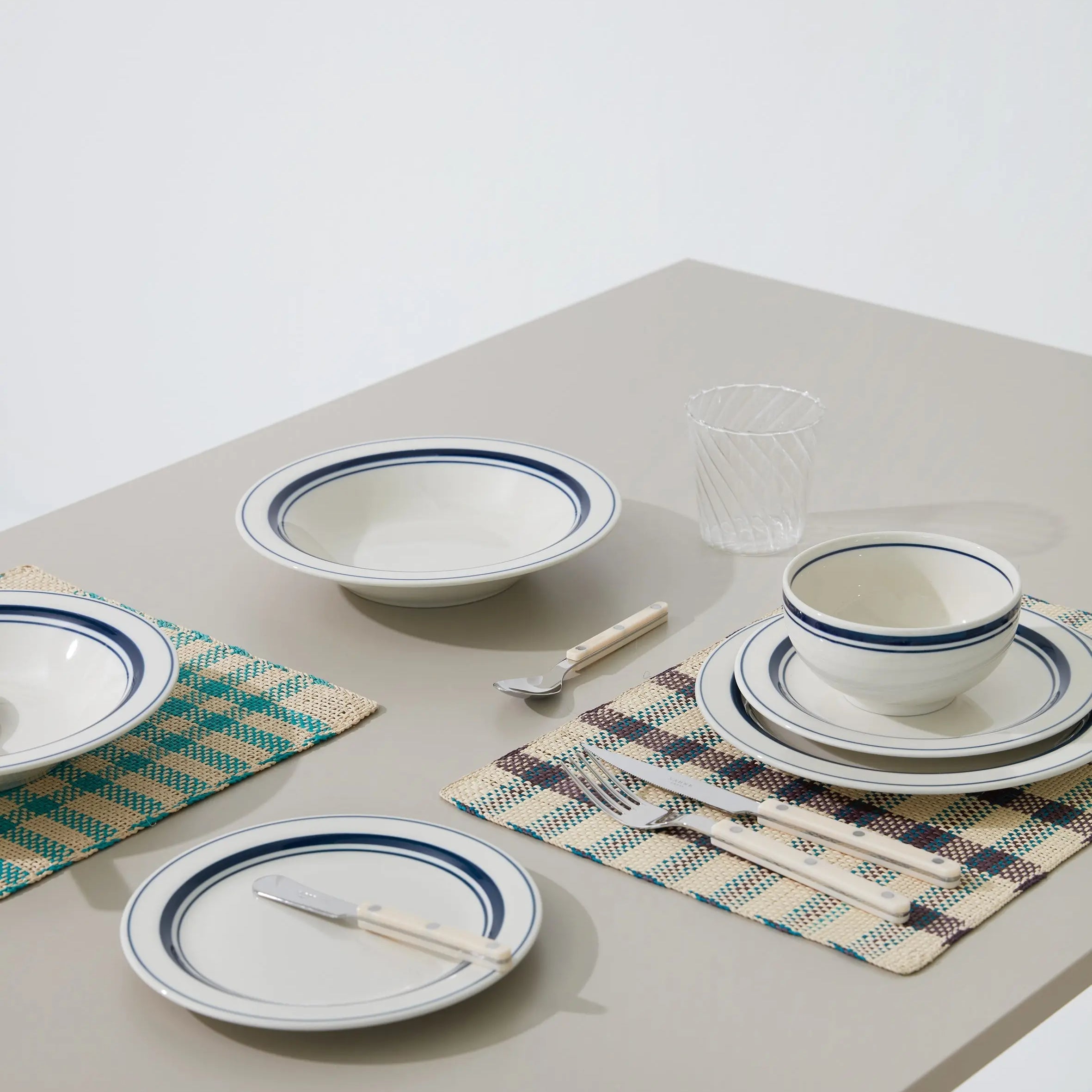 Japanese ceramic plates, bowls, and tableware with blue rim design – elegant dinnerware set for modern dining.