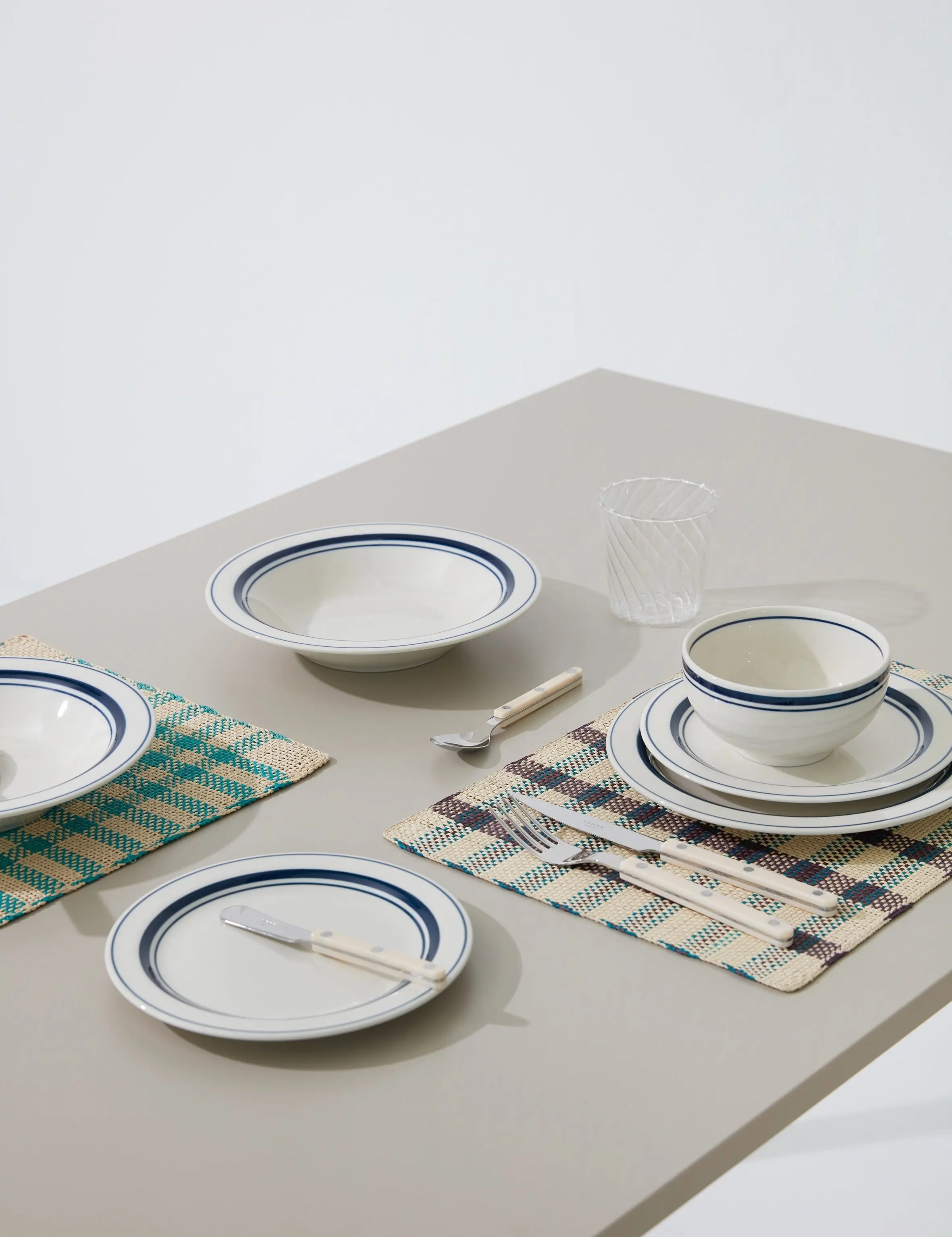 Japanese ceramic plates, bowls, and tableware with blue rim design – elegant dinnerware set for modern dining.