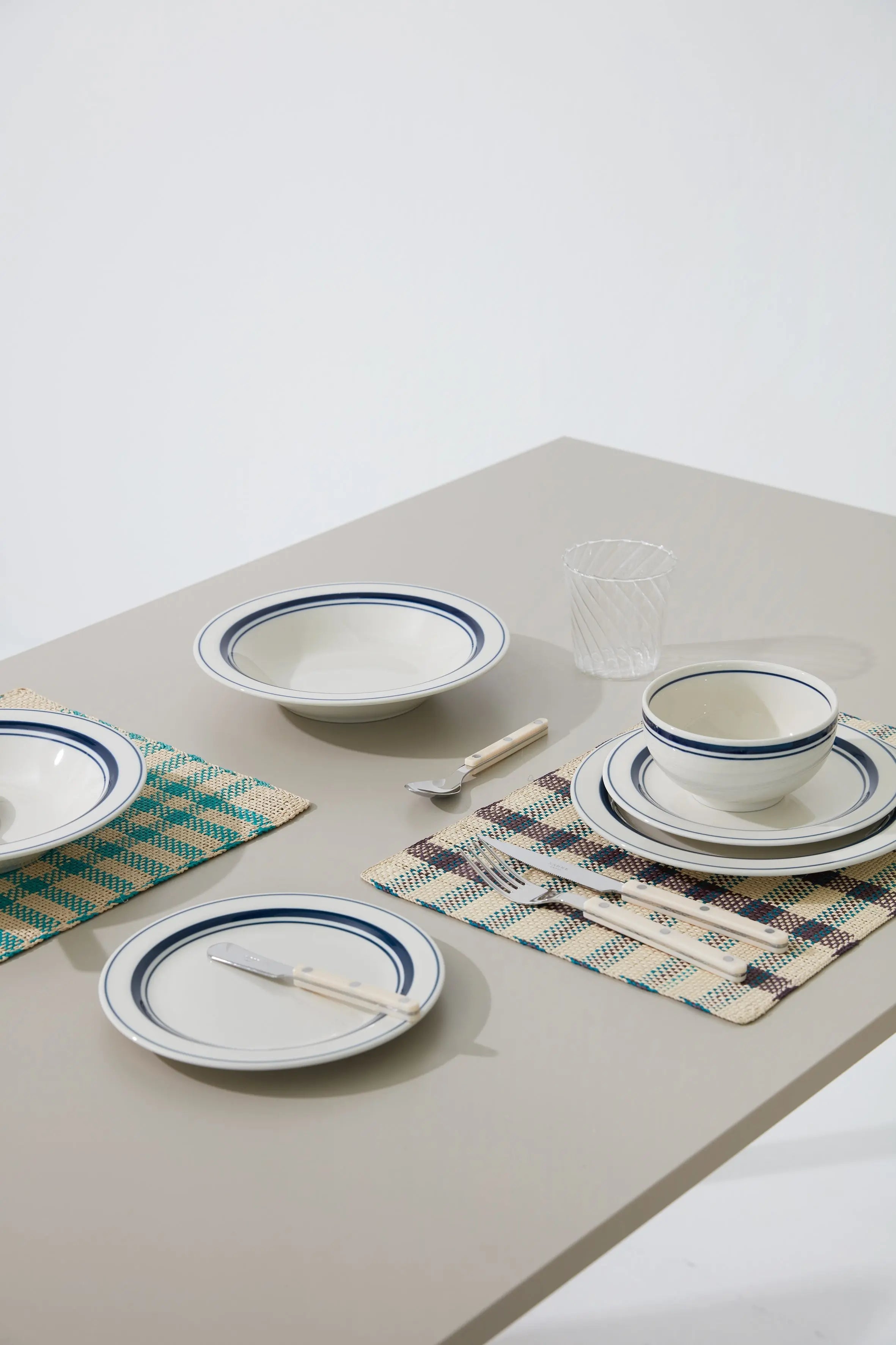Japanese ceramic plates, bowls, and tableware with blue rim design – elegant dinnerware set for modern dining.