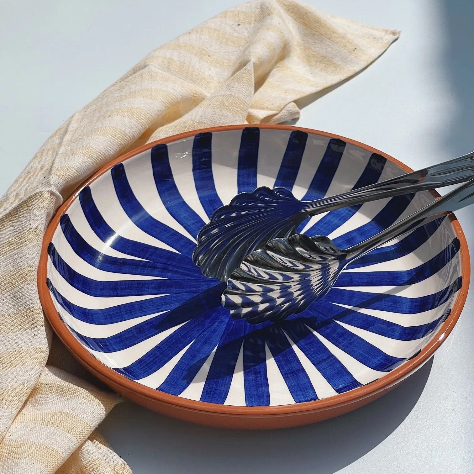 Casa Cubista Ray dish in terracotta with hand-painted blue and white stripes