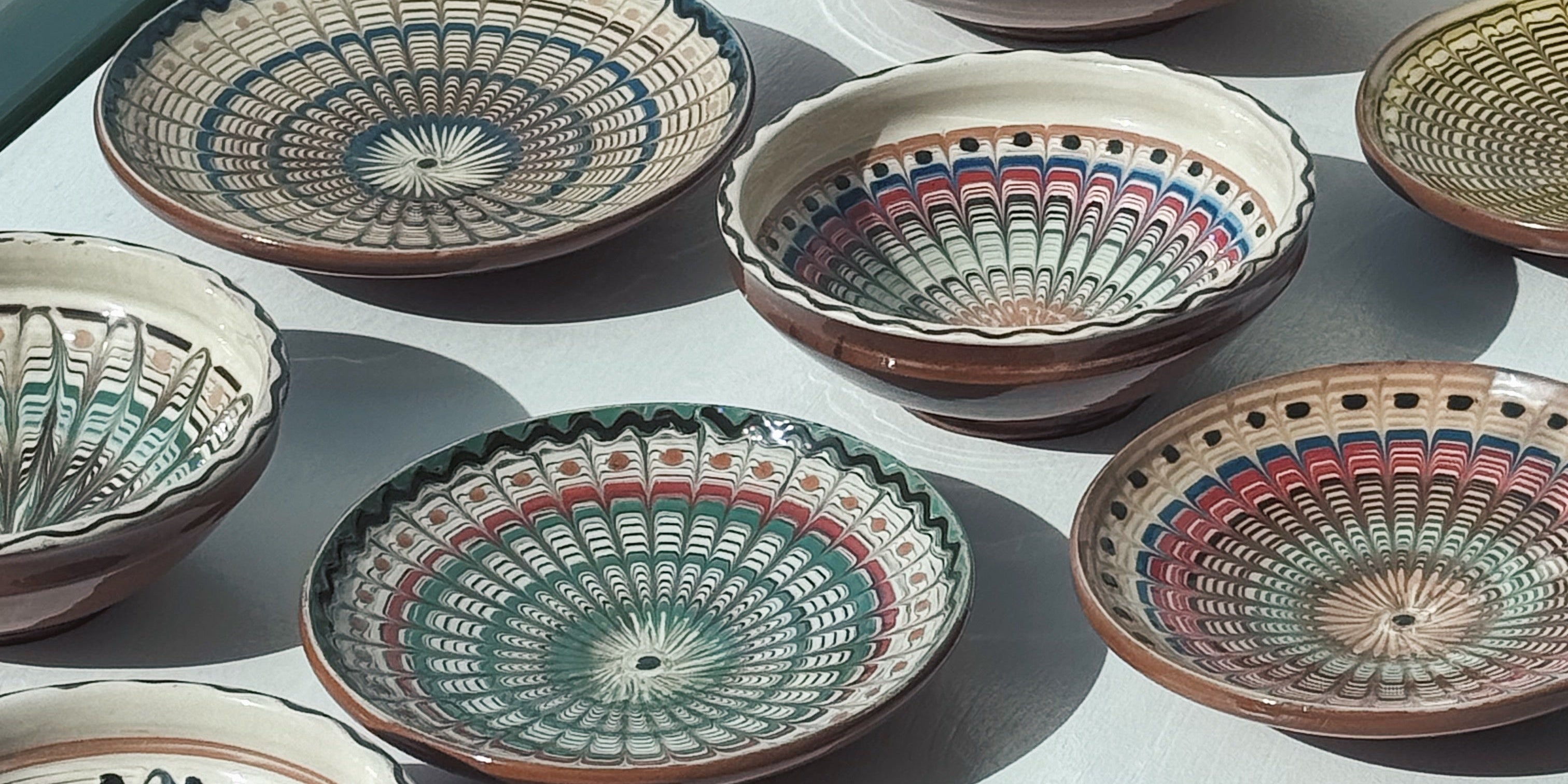 Hand painted Horezu pottery bowls from Romania in different sizes and patterns – traditional UNESCO recognised ceramic craftsmanship.