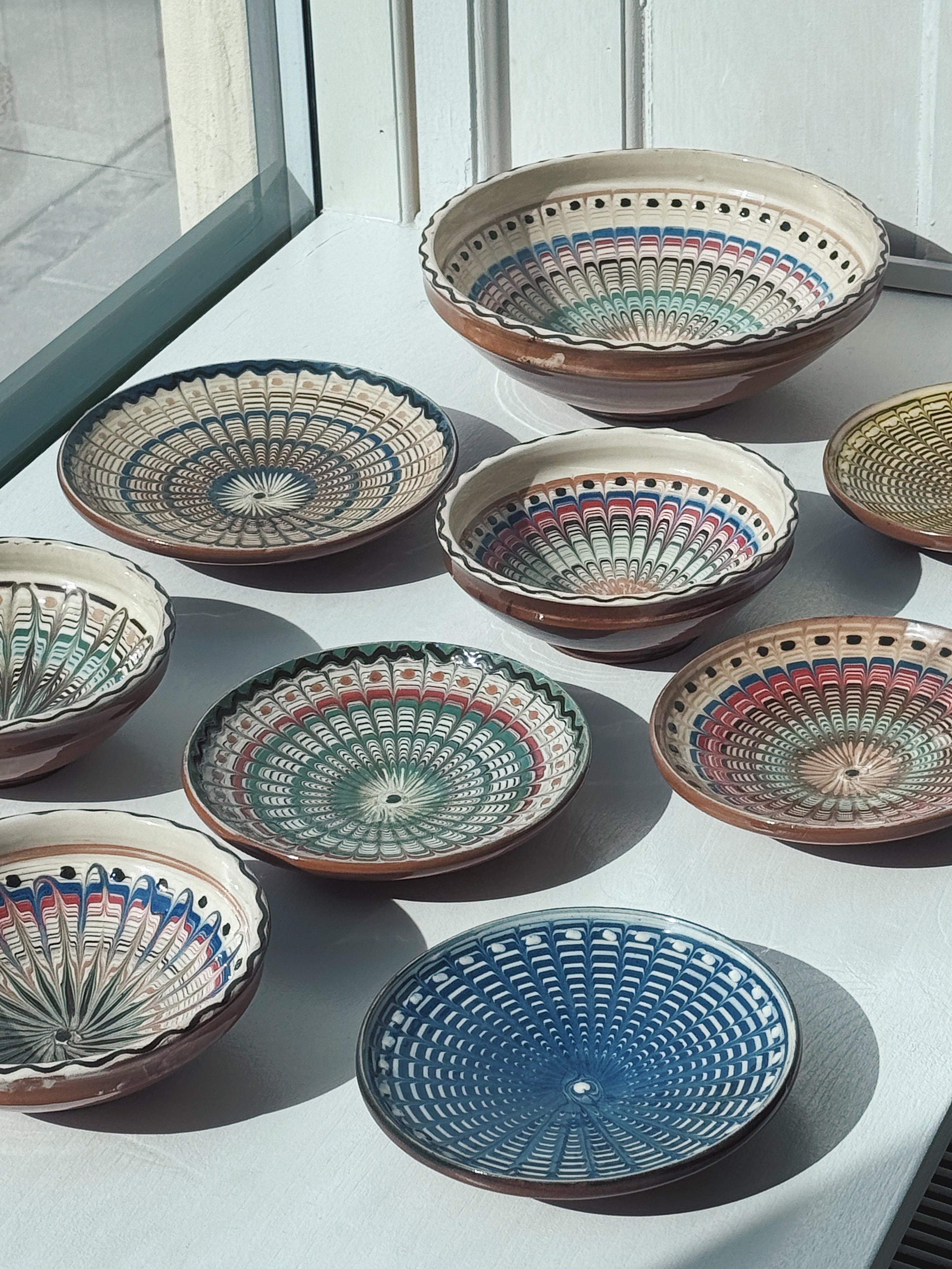 Hand painted Horezu pottery bowls from Romania in different sizes and patterns – traditional UNESCO recognised ceramic craftsmanship.