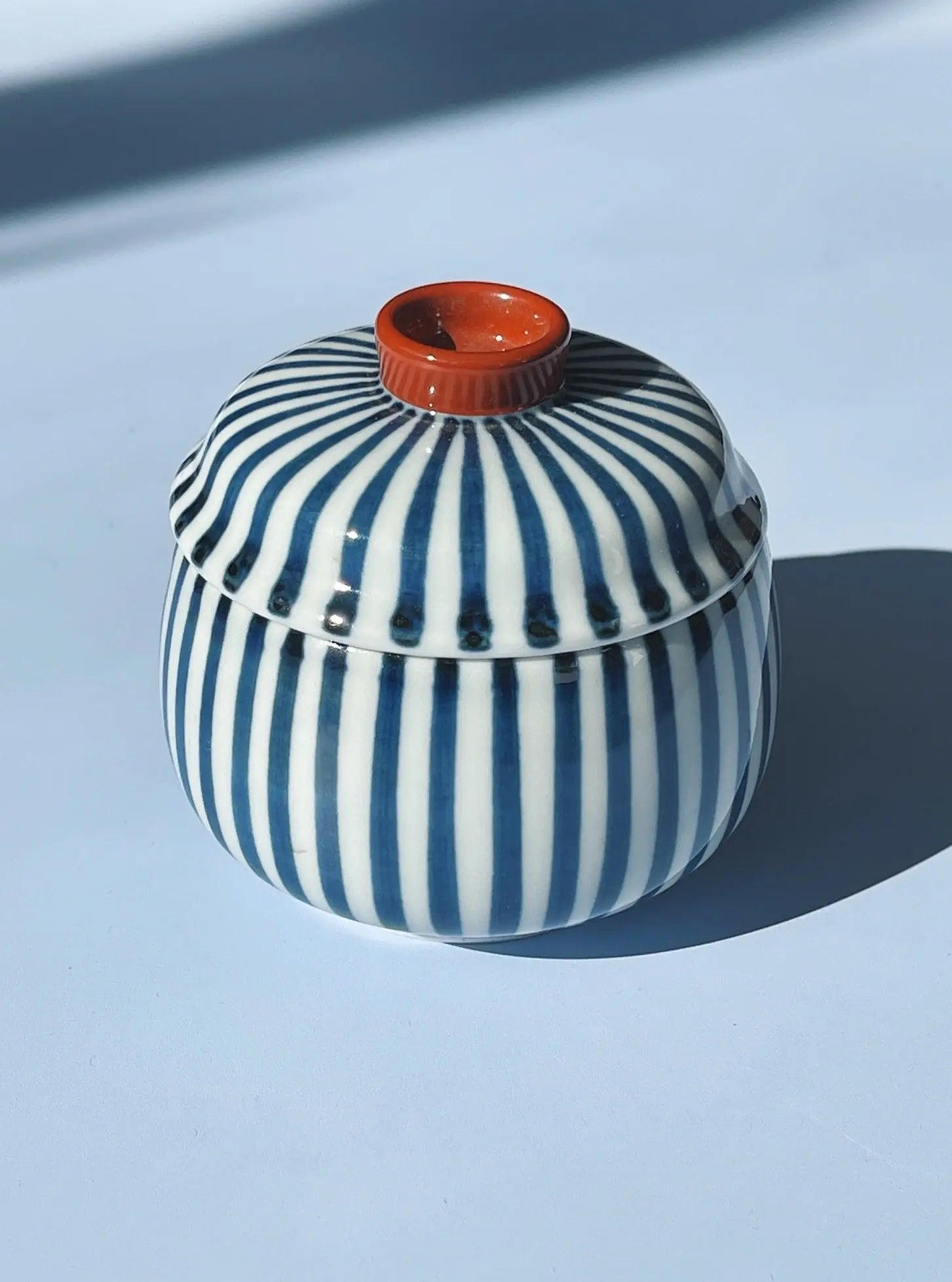Japanese ceramic lidded jar with blue and white stripes and red detail – Studio Hafnia