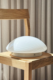 Vintage Murano plafond ceiling lamp in white swirl glass on a wooden chair, seen from the side, Ø32 cm