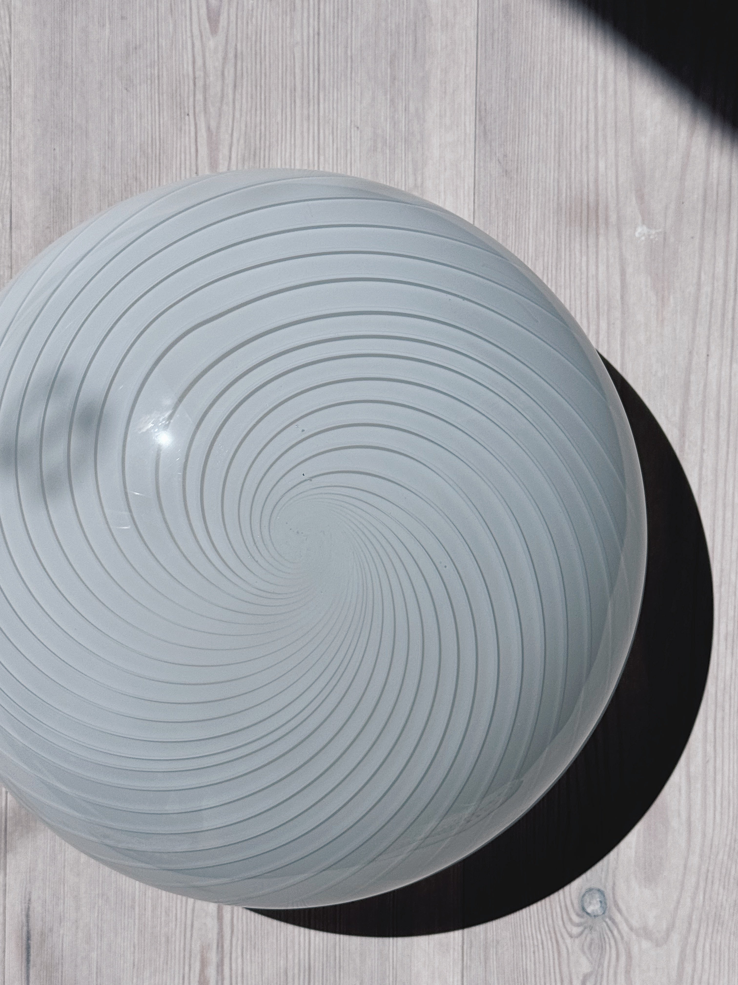 White Murano plafond ceiling lamp in swirl glass seen close up from above at an angle, Ø28 cm