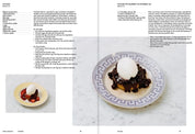 Recipe for pancakes with blueberry jam and whipped cream on a plate with a Greek key pattern
