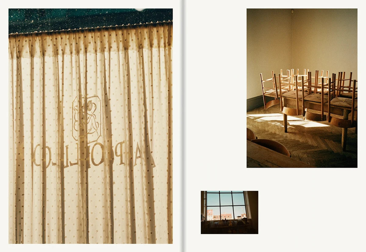 Apollo logo on a light curtain backlit by the sun and the empty dining room with wooden chairs stacked on the tables