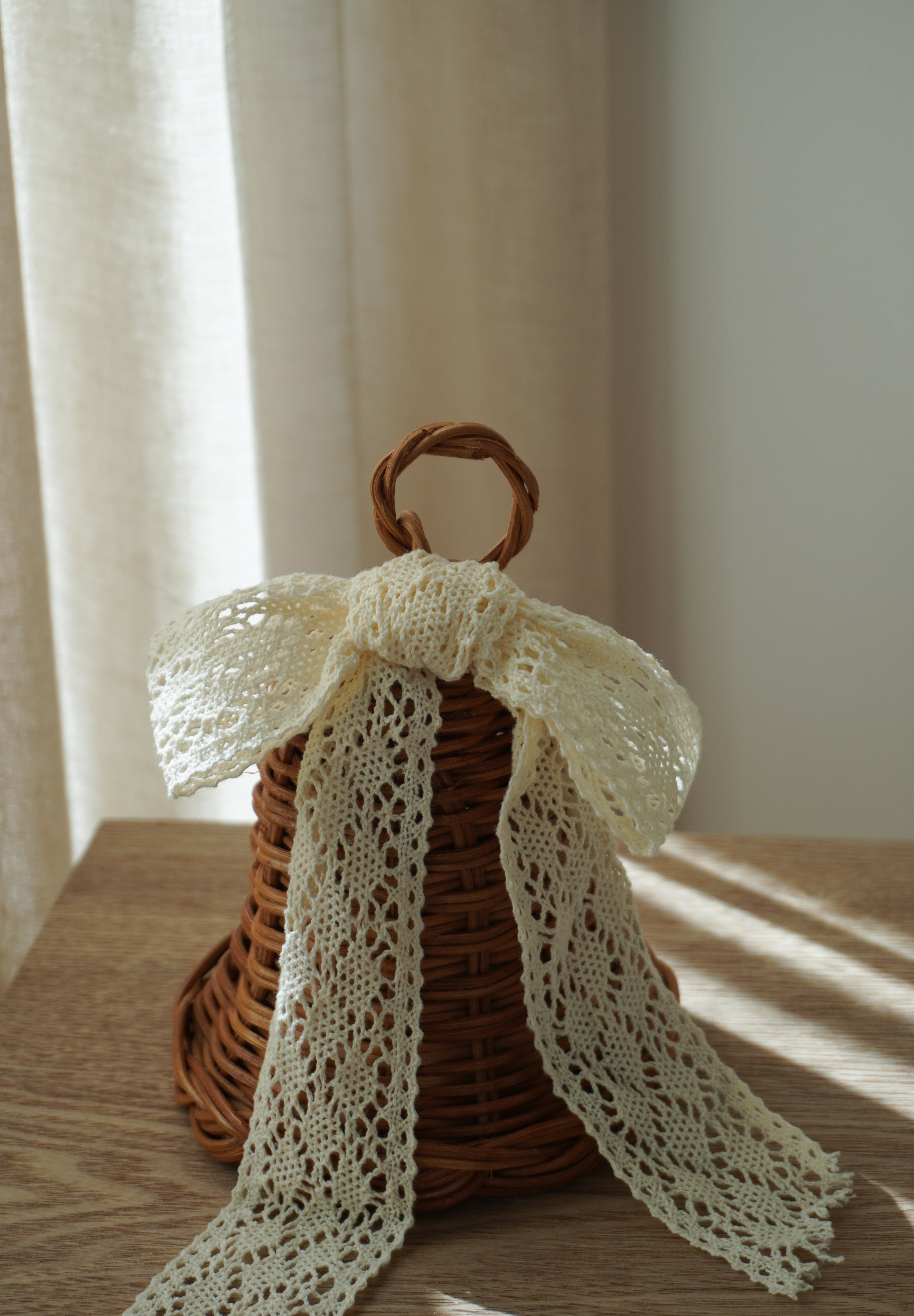 Stående rattan juleklokke med hvid blondesløjfe, 12,5 x 12,5 cm