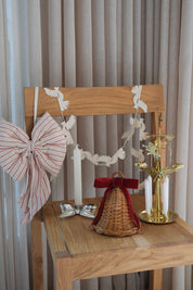 Studio Hafnia Christmas package with rattan Christmas bell, striped Christmas bow, silver candlestick, brass angel chime and paper dove garland
