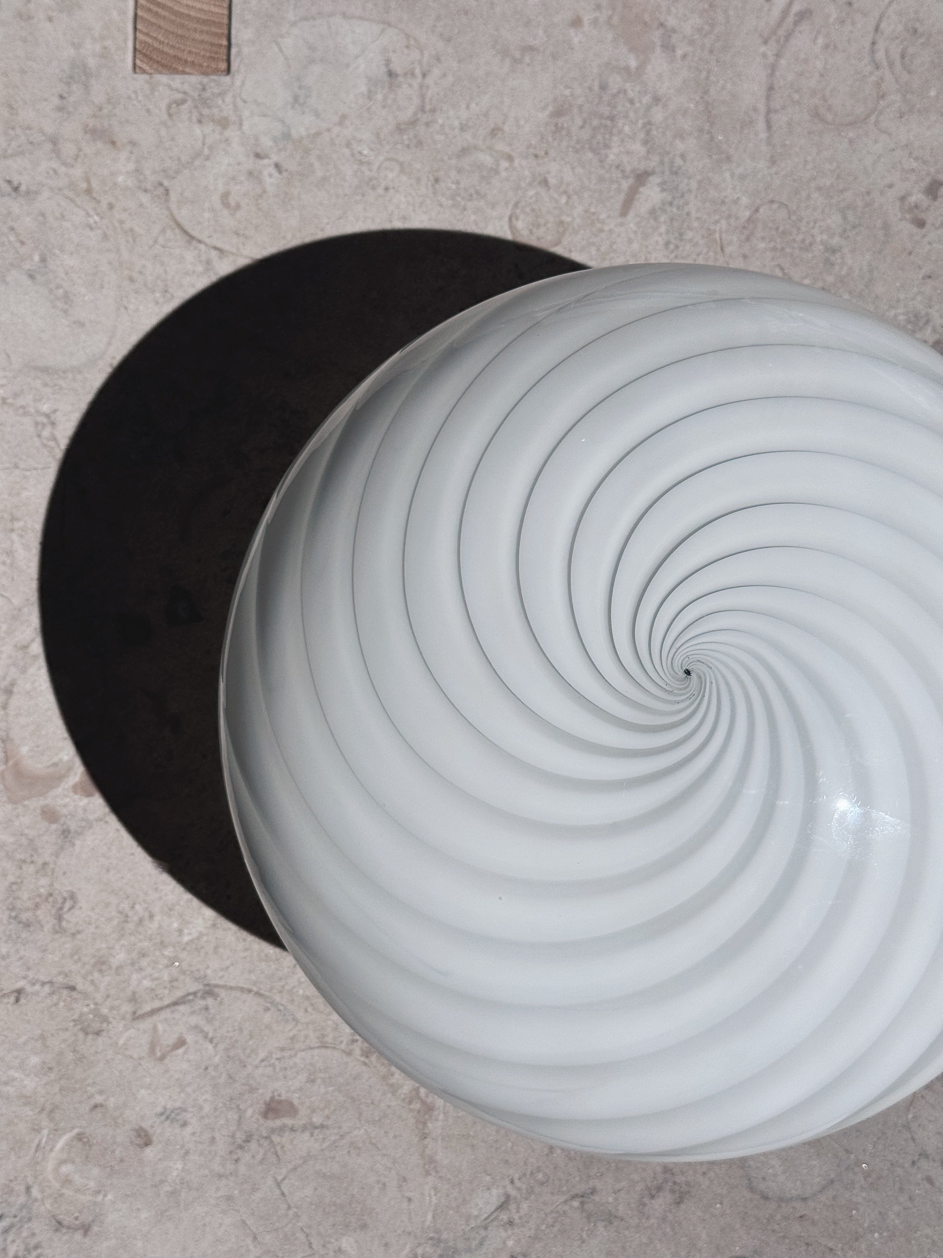 White Murano swirl flush mount seen from above with spiral pattern in the centre