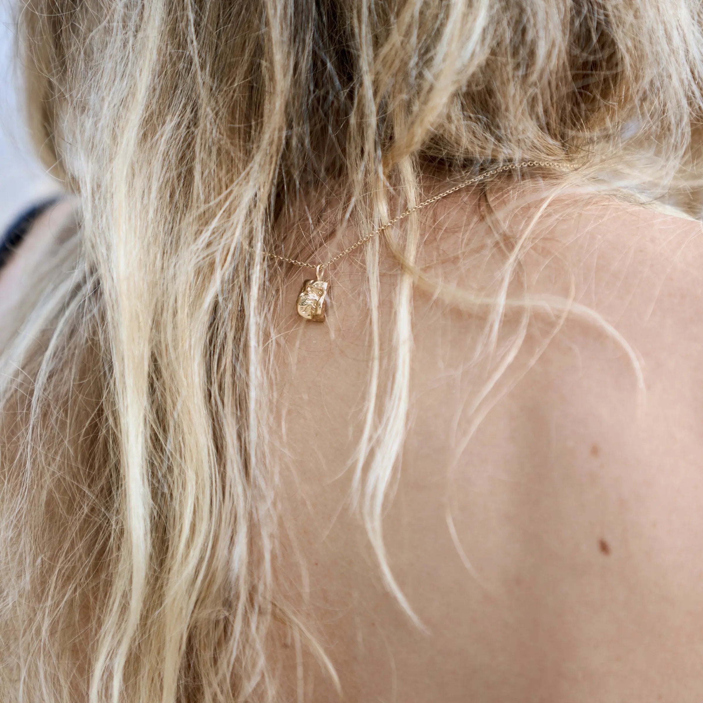 Inger necklace in solid 14 carat gold by Christina Iversen Studio worn with the pendant at the nape