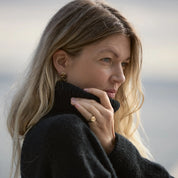Inger ring in 14 carat gold worn with black knitwear alongside the Inger gold earrings