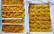 Spread from the Osteria 16 cookbook with freshly rolled pasta in many shapes laid out on white cloth