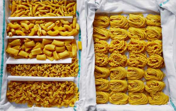 Spread from the Osteria 16 cookbook with freshly rolled pasta in many shapes laid out on white cloth