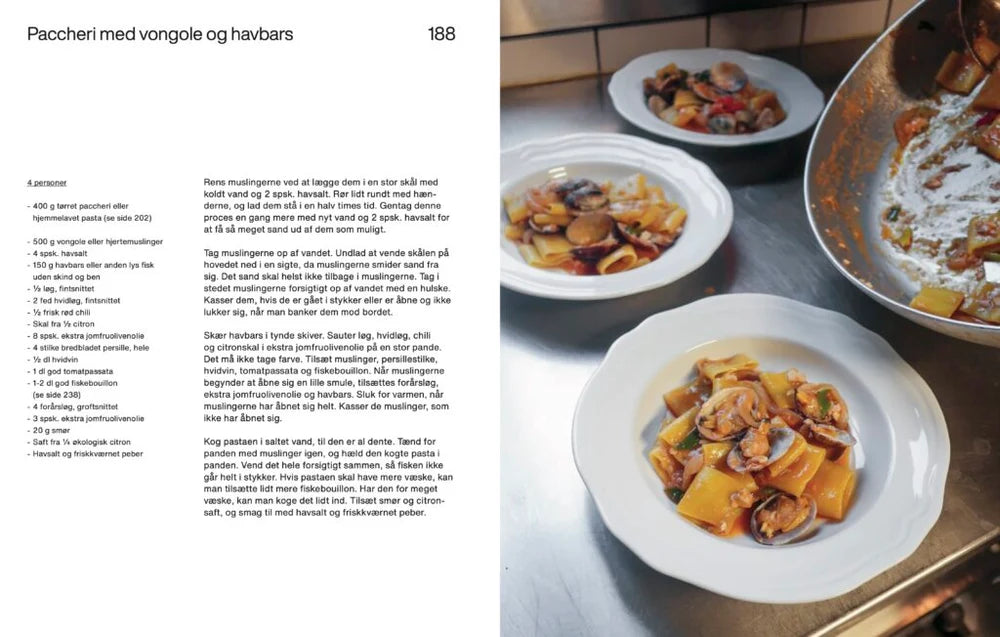 Opskrift på paccheri med vongole og havbars serveret på hvid tallerken i køkkenet