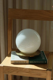 Close-up of the white swirl pattern in mouth-blown Murano glass on a vintage table lamp