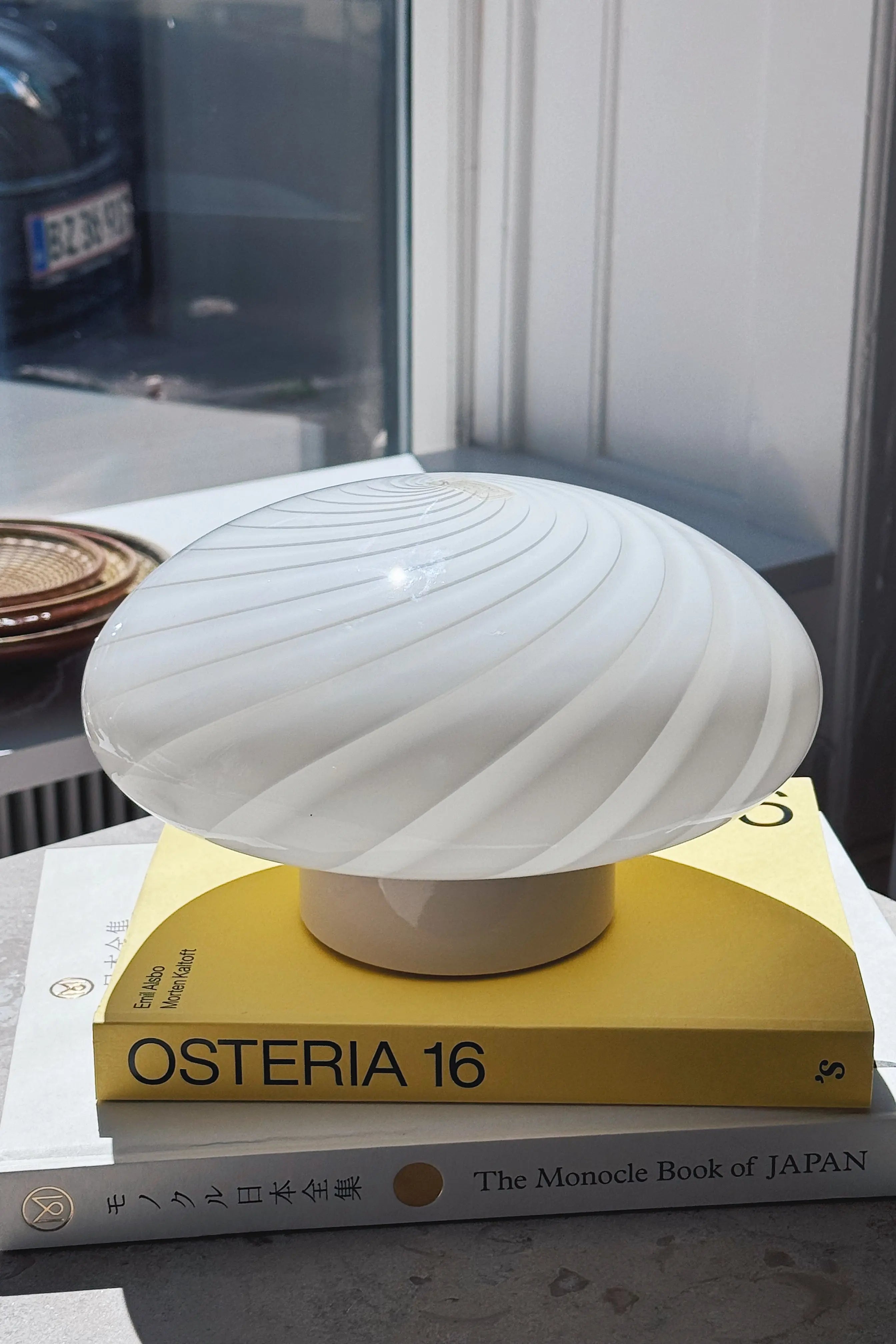 Vintage Murano ceiling light in white swirl glass photographed in window light