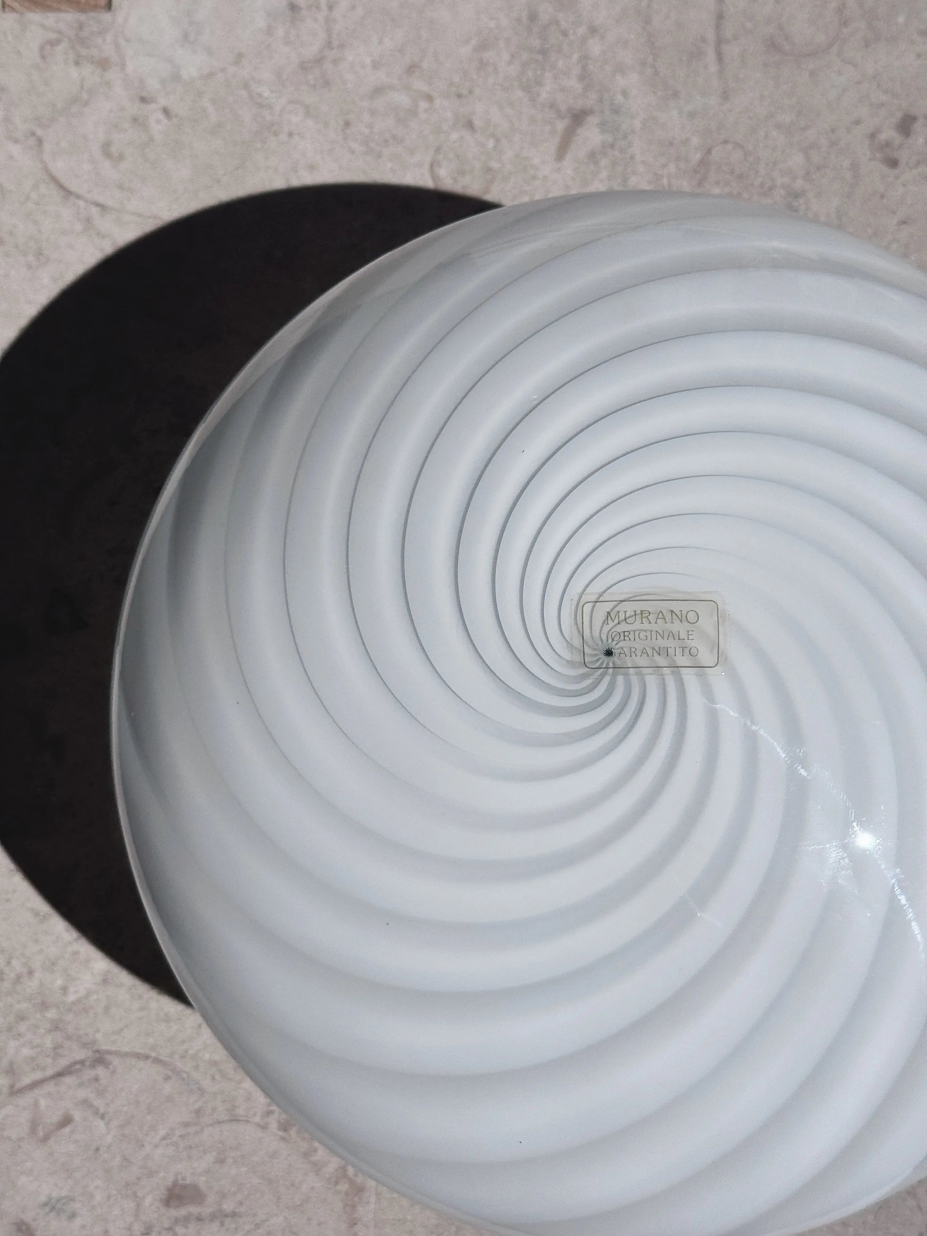 White Murano swirl flush mount from above with original Murano label in the centre