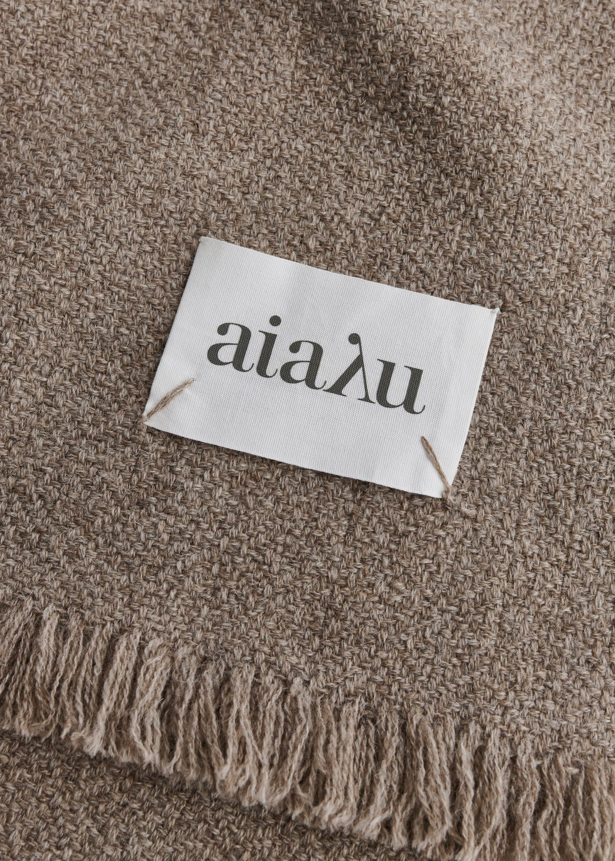 Aiayu Haya throw in Pure Soil – close-up of the jacquard weave and fringes in sartuul wool