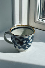 Japanese ceramic mug in white with dark blue karakusa pattern and brown rim, 250 ml