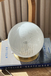 Close-up of the hair-fine white filigrana lines gathering into a star at the top of the Murano globe