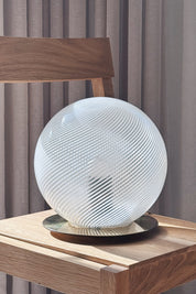 Close-up of the white Murano globe lamp's spiralled glass and round polished brass base