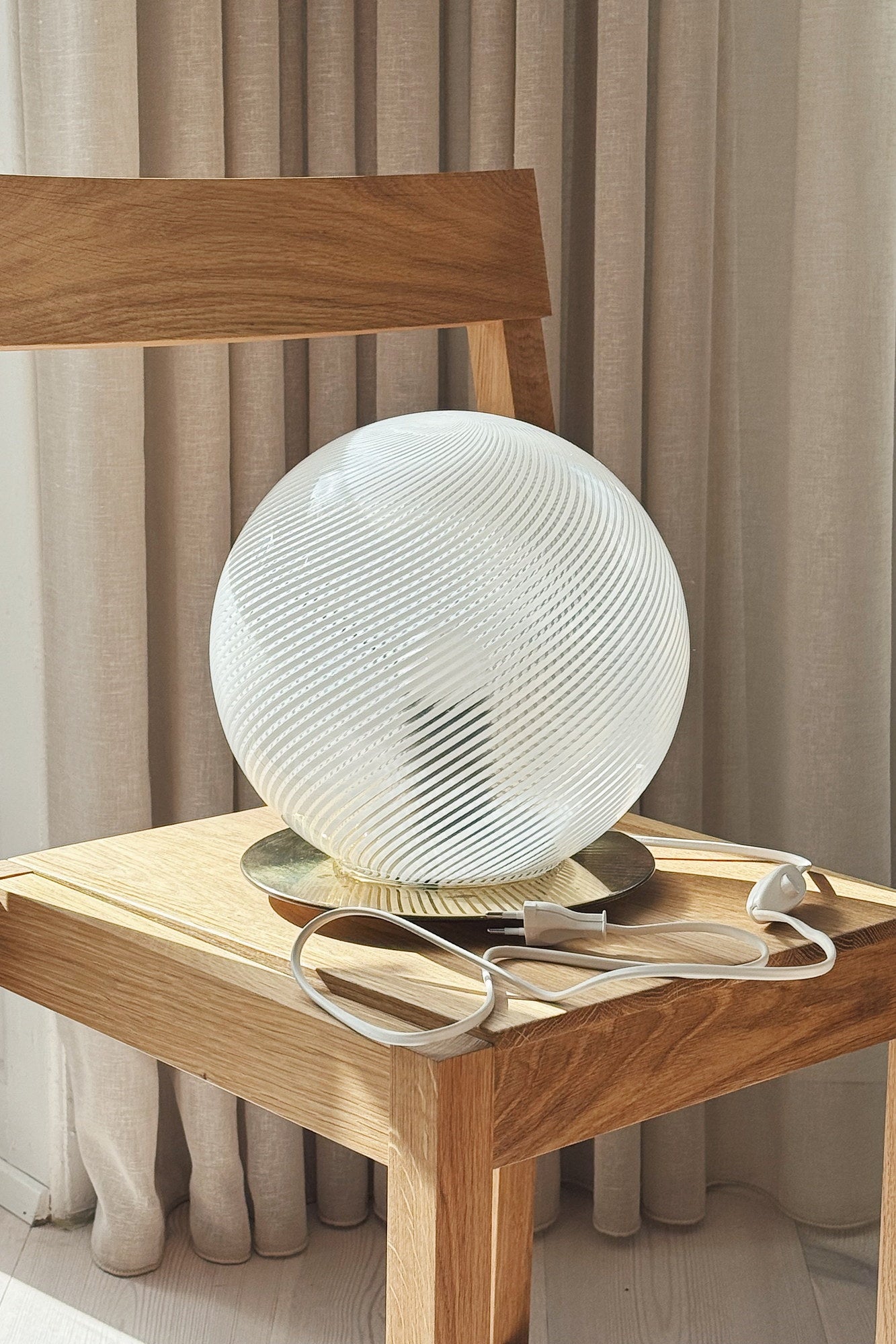 White Murano globe table lamp on an oak chair with new white cord and switch