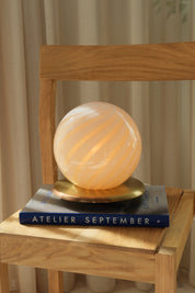 Mouth-blown Murano sphere in opal white glass with light yellow swirl stripes, vintage table lamp